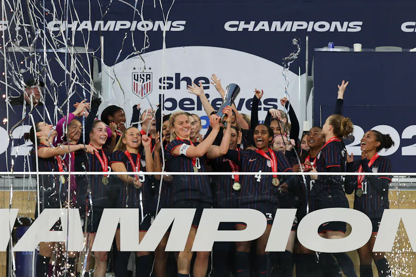The USWNT hold up the SheBelieves Cup.