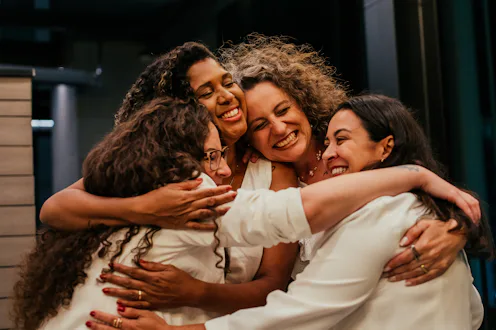 Female friends hugging each other on New Year's Eve