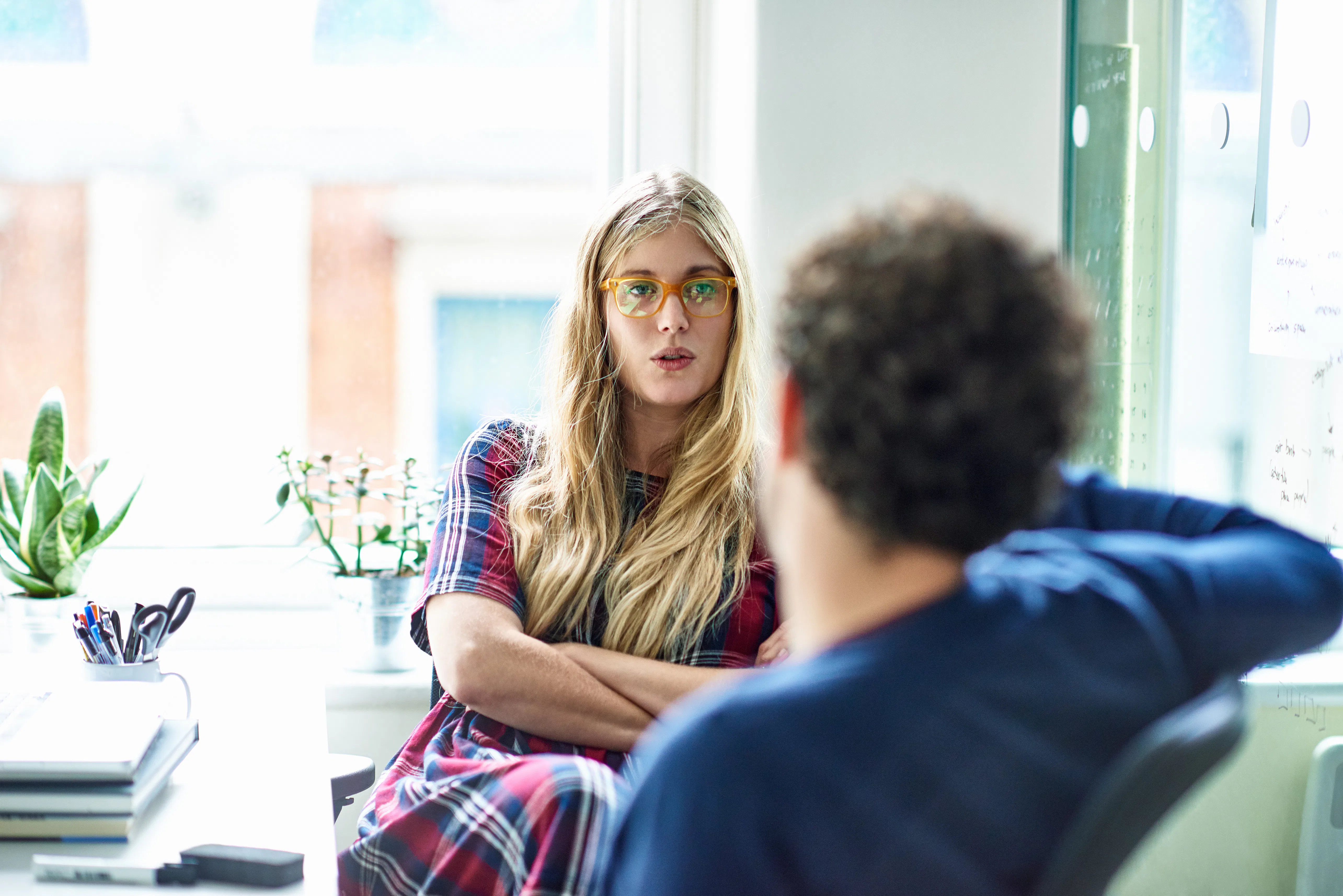 Businesswoman and businessman talking in modern office.