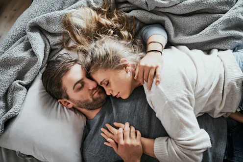High angle shot of a happy young couple having a nap together in the bedroom at home