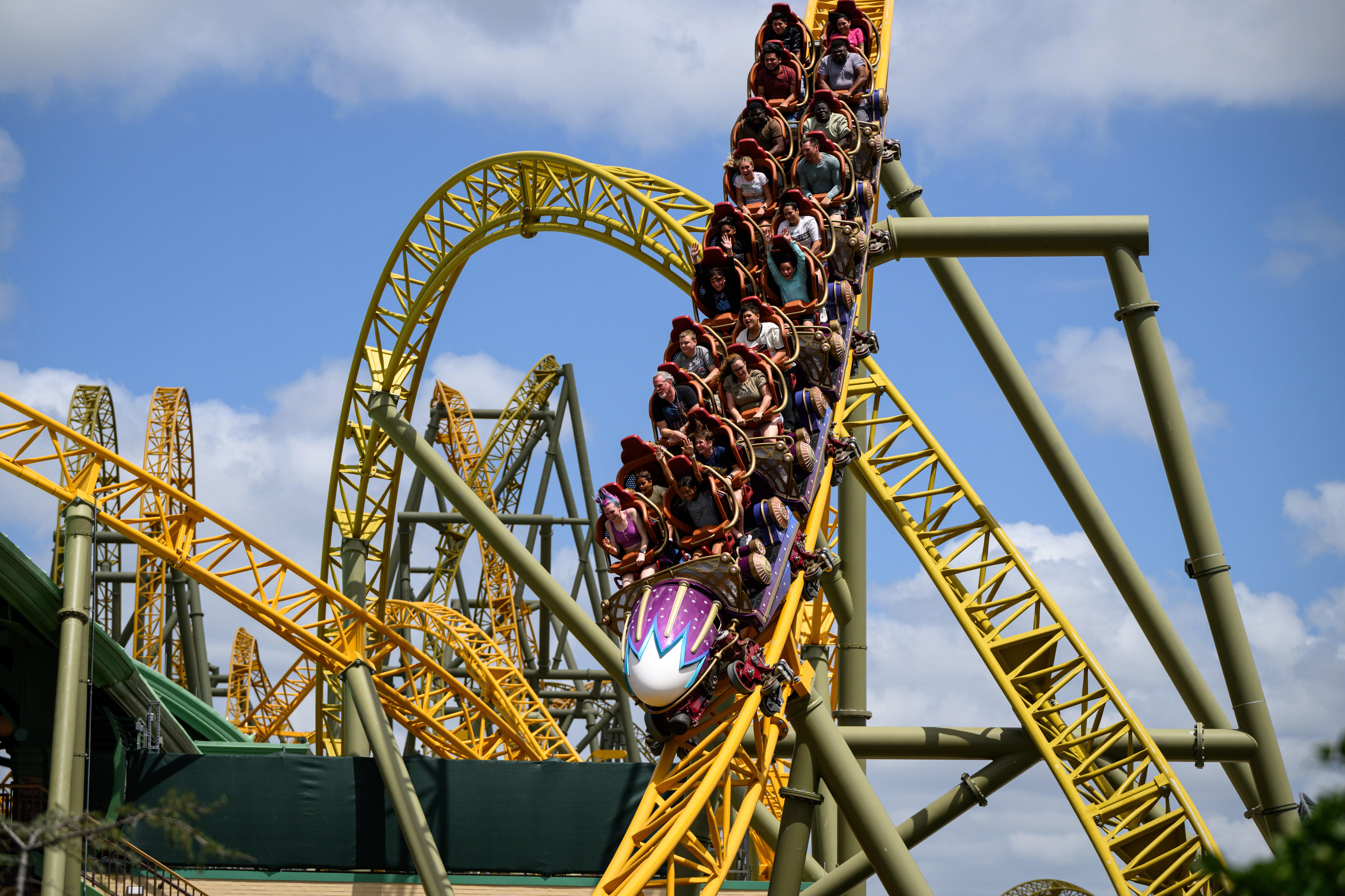 Guests ride the Stardust Racers rollercoaster in the Celestial Park area, at the Epic Universe theme...