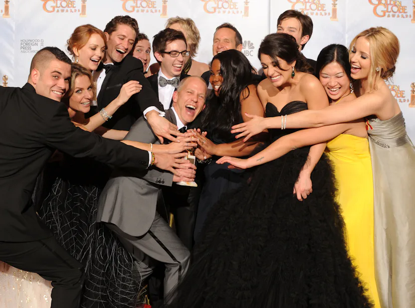 Ryan Murphy poses with the cast of "Glee" at the 67th Annual Golden Globe Awards