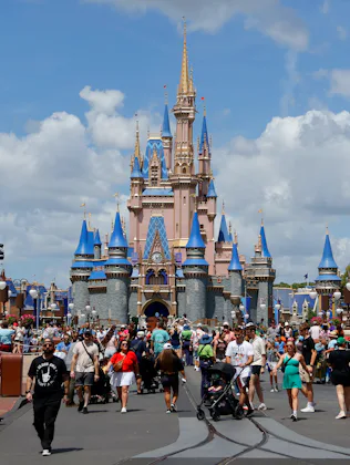 ORLANDO, FL - APRIL 3: People walk past the front of Cinderella's Castle at the Magic Kingdom Park a...