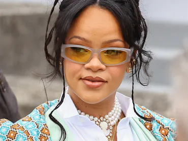 Rihanna at the Dior Homme Menswear Spring/Summer 2026 show in sunglasses and an updo