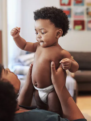 Shot of an adorable baby girl bonding with her mother at home