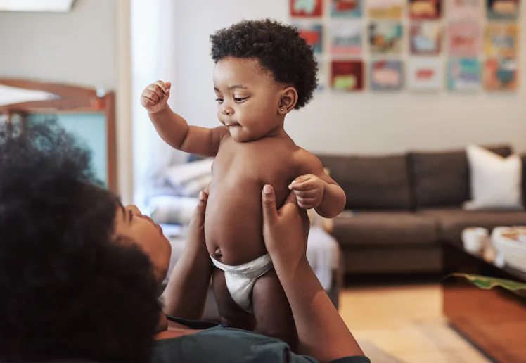Shot of an adorable baby girl bonding with her mother at home