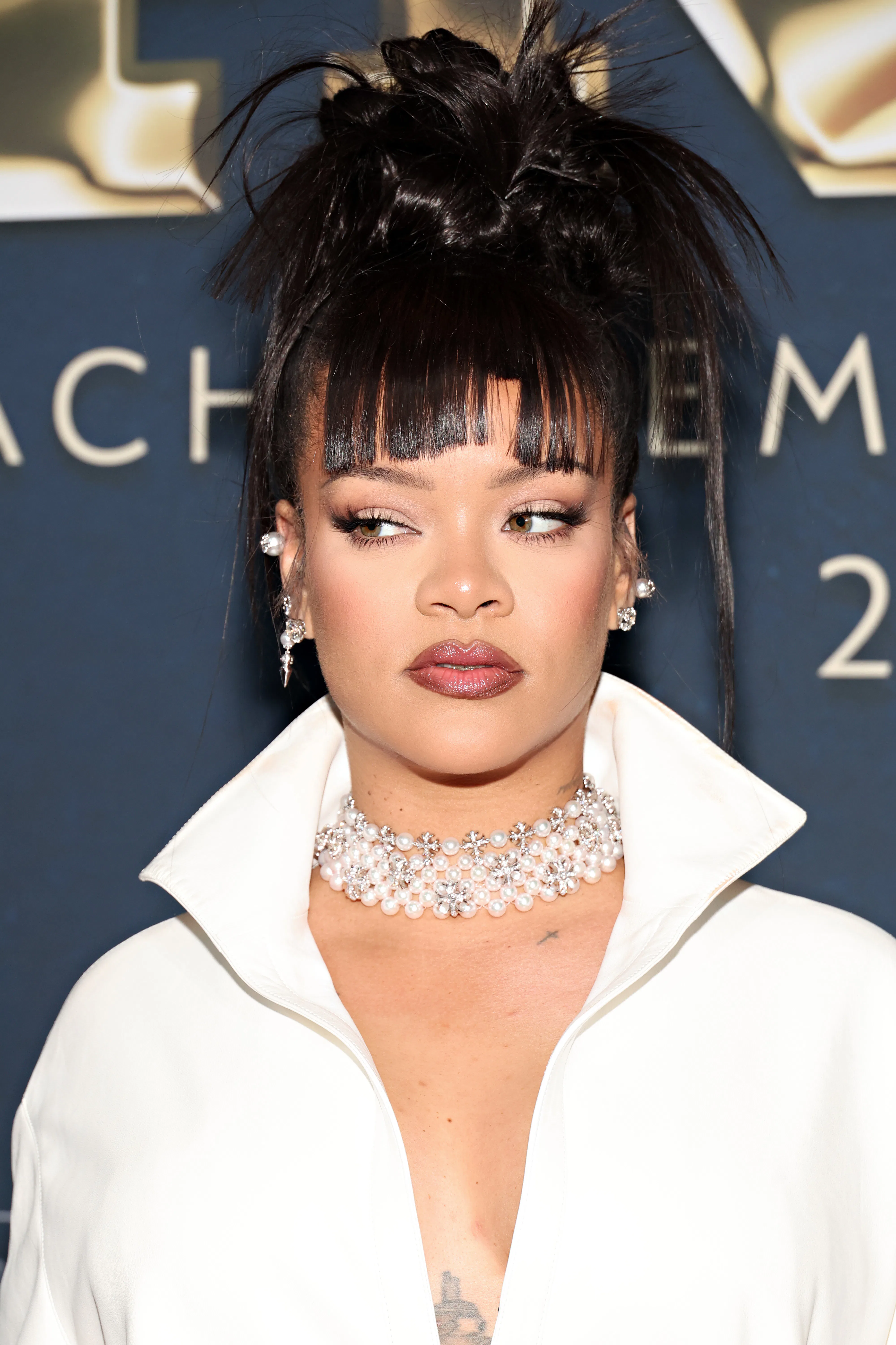 Rihanna with bangs and a spiky updo