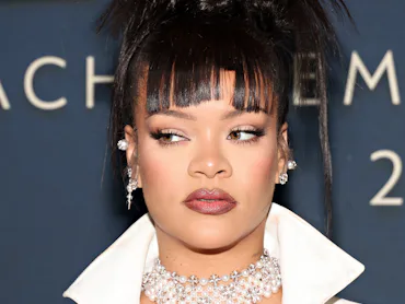 Rihanna with bangs and a spiky updo