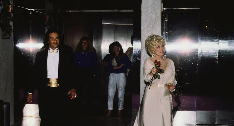 Dolly Parton with an unidentified man in New York City, New York, United States, circa 1990s. (Photo...