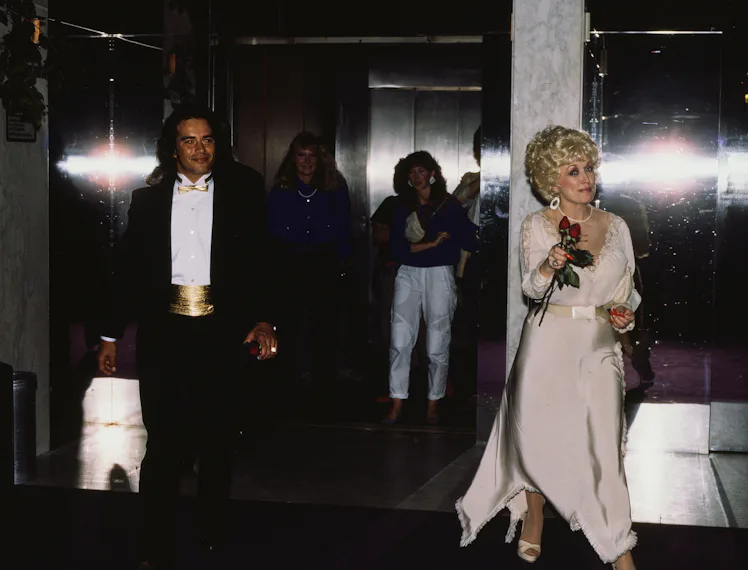 Dolly Parton with an unidentified man in New York City, New York, United States, circa 1990s. (Photo...