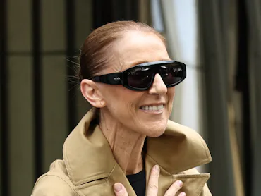 Canadian singer Celine Dion acknowledges fans as she arrives at Hotel Le Royal Monceau in Paris on A...