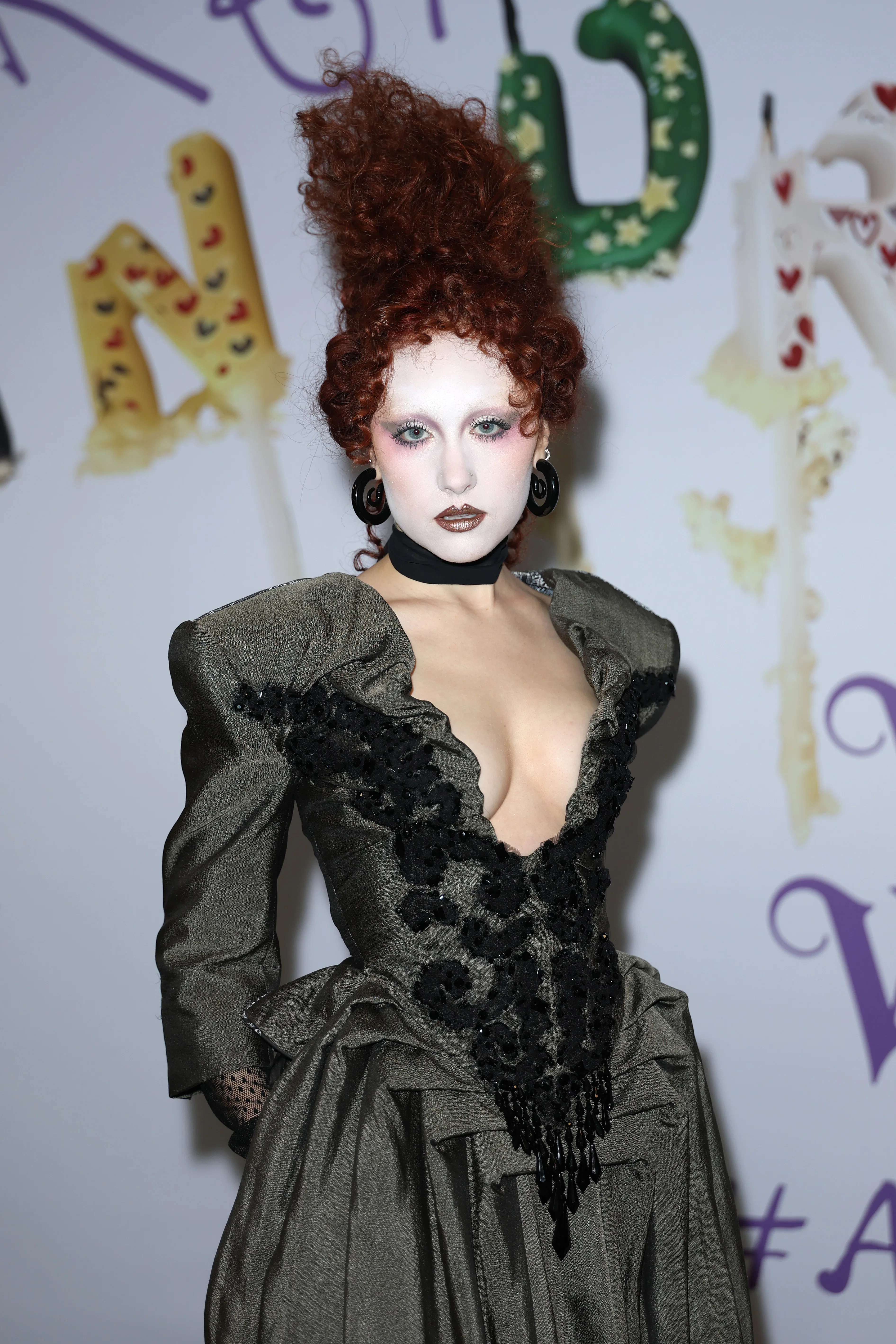 Chappell Roan with her hair piled up into a fantastical red updo at a Vivienne Westwood show