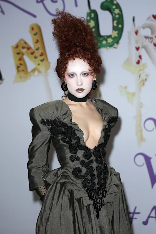 Chappell Roan with her hair piled up into a fantastical red updo at a Vivienne Westwood show