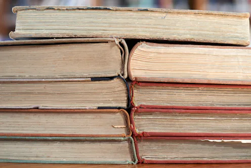 Stacked old books with worn pages and covers symbolize knowledge, learning, literature, history, edu...