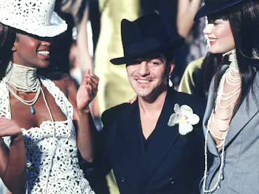 PARIS, FRANCE - JANUARY 20: Fashion designer John Galliano and Naomi Campbell walk the runway during...