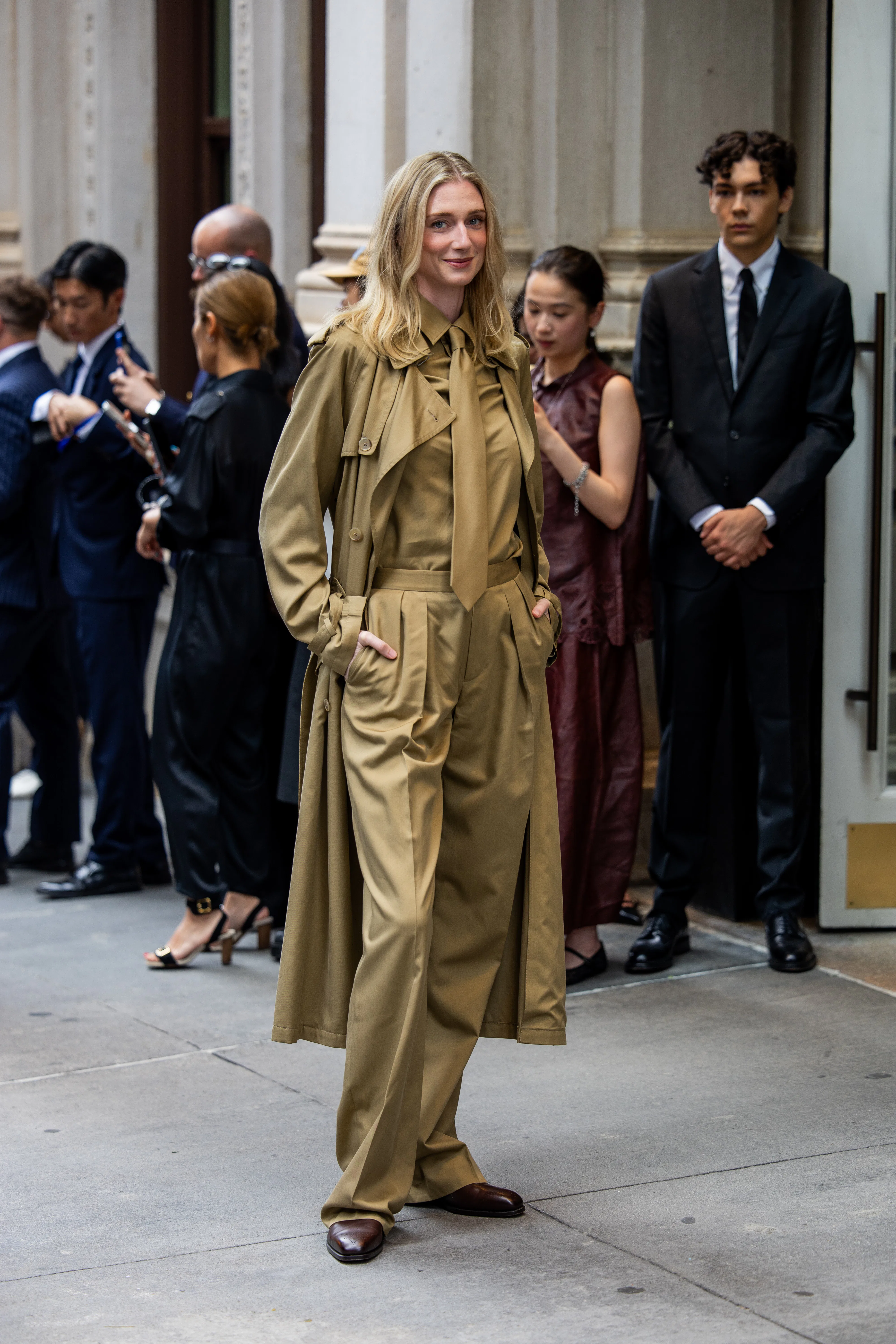 NEW YORK, NEW YORK - SEPTEMBER 09: Elizabeth Debicki wears beige shirt, tie, coat, pants outside Ral...