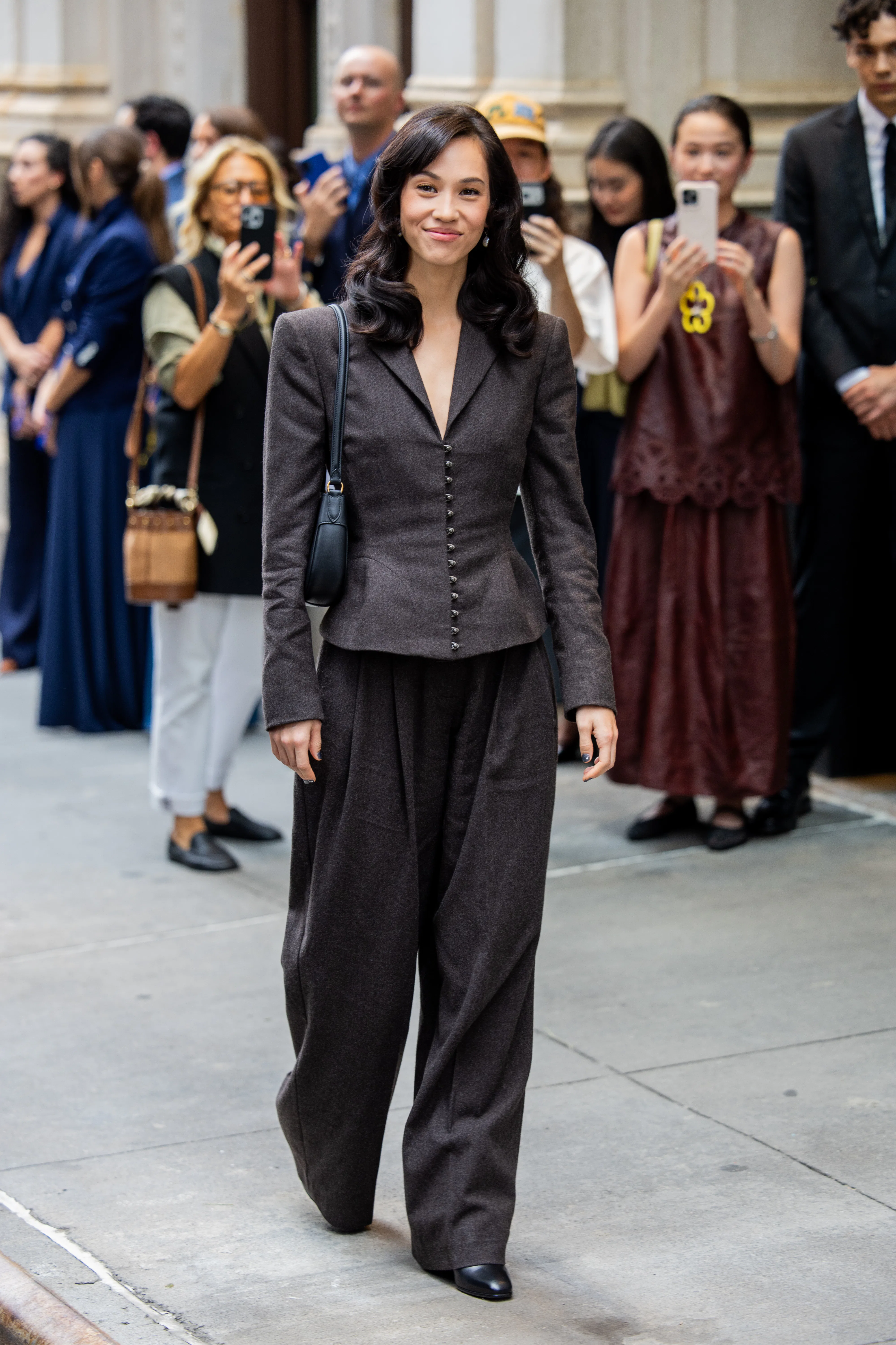 NEW YORK, NEW YORK - SEPTEMBER 09: Kiko Mizuhara wears grey blazer jacket, wide leg pants, bag outsi...