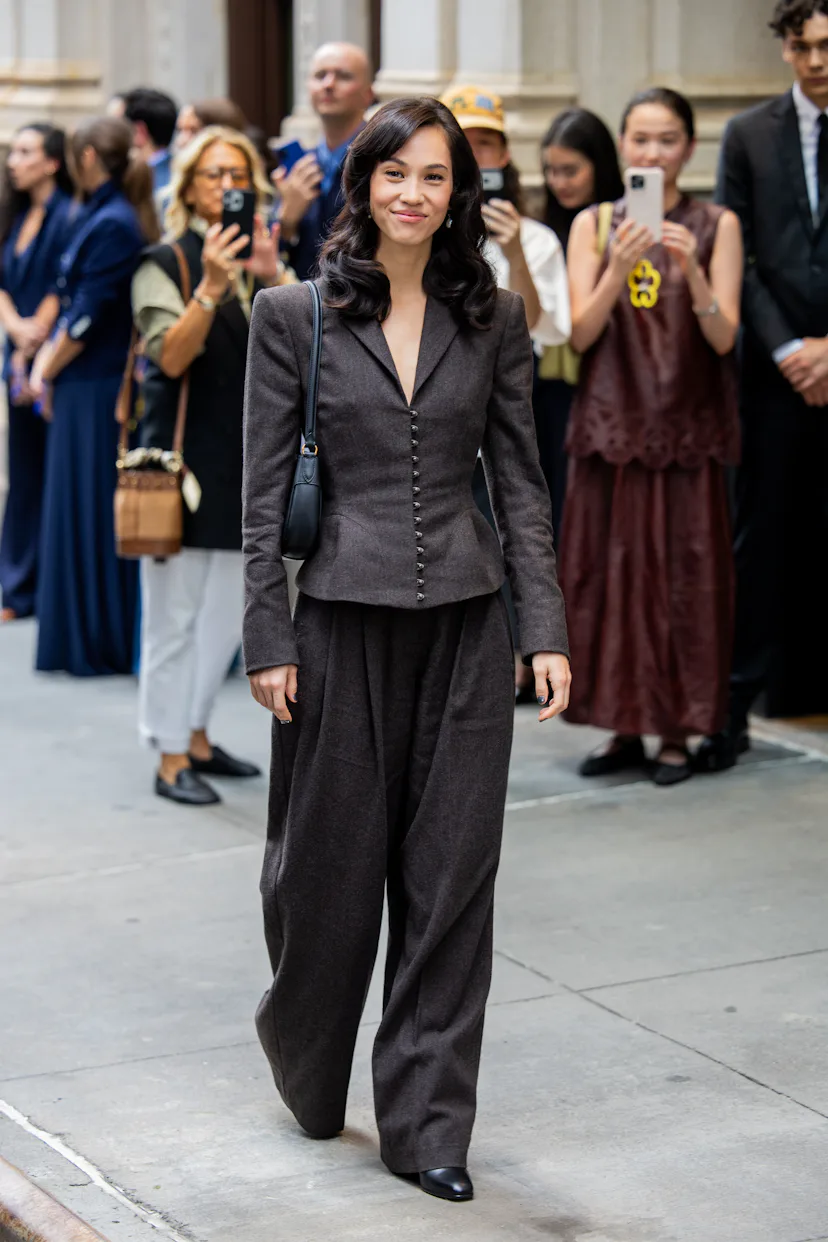 NEW YORK, NEW YORK - SEPTEMBER 09: Kiko Mizuhara wears grey blazer jacket, wide leg pants, bag outsi...