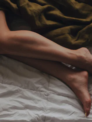 Beautiful Female bare, smooth legs, visible areas of calves, ankles and feet, thigh covered with a k...