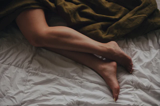 Beautiful Female bare, smooth legs, visible areas of calves, ankles and feet, thigh covered with a k...