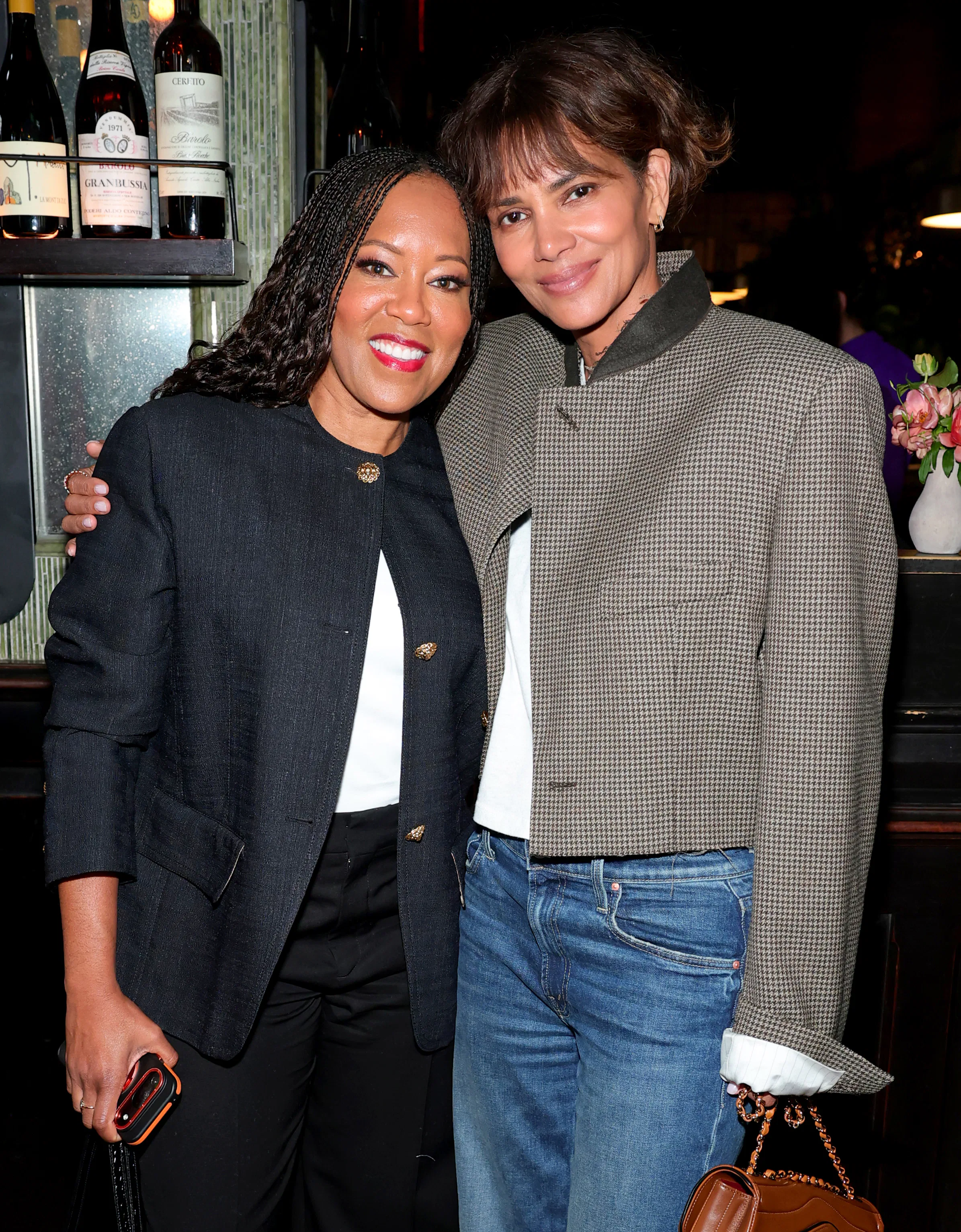 NEW YORK, NEW YORK - SEPTEMBER 22: (L-R) Regina King and Halle Berry attend the Through Her Lens: Th...