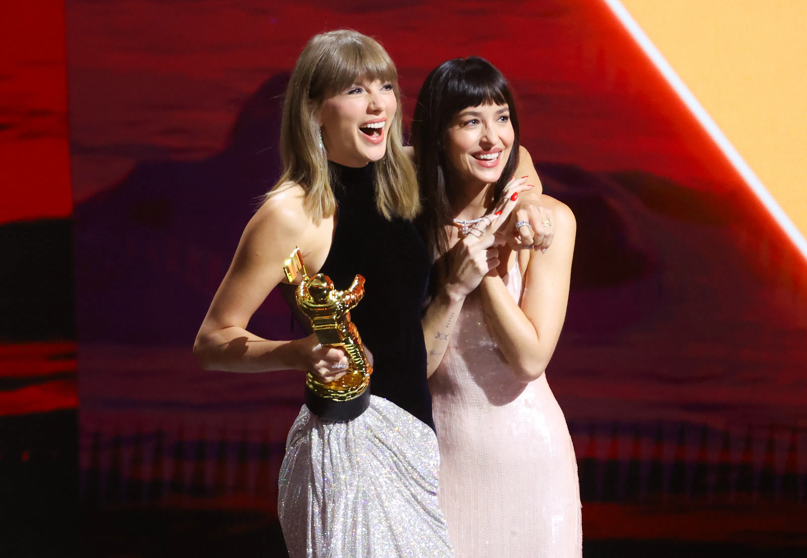 Taylor Swift and Dakota Johnson onstage as Swift accepts the Artist Director Honors at 2026 MTV Vide...