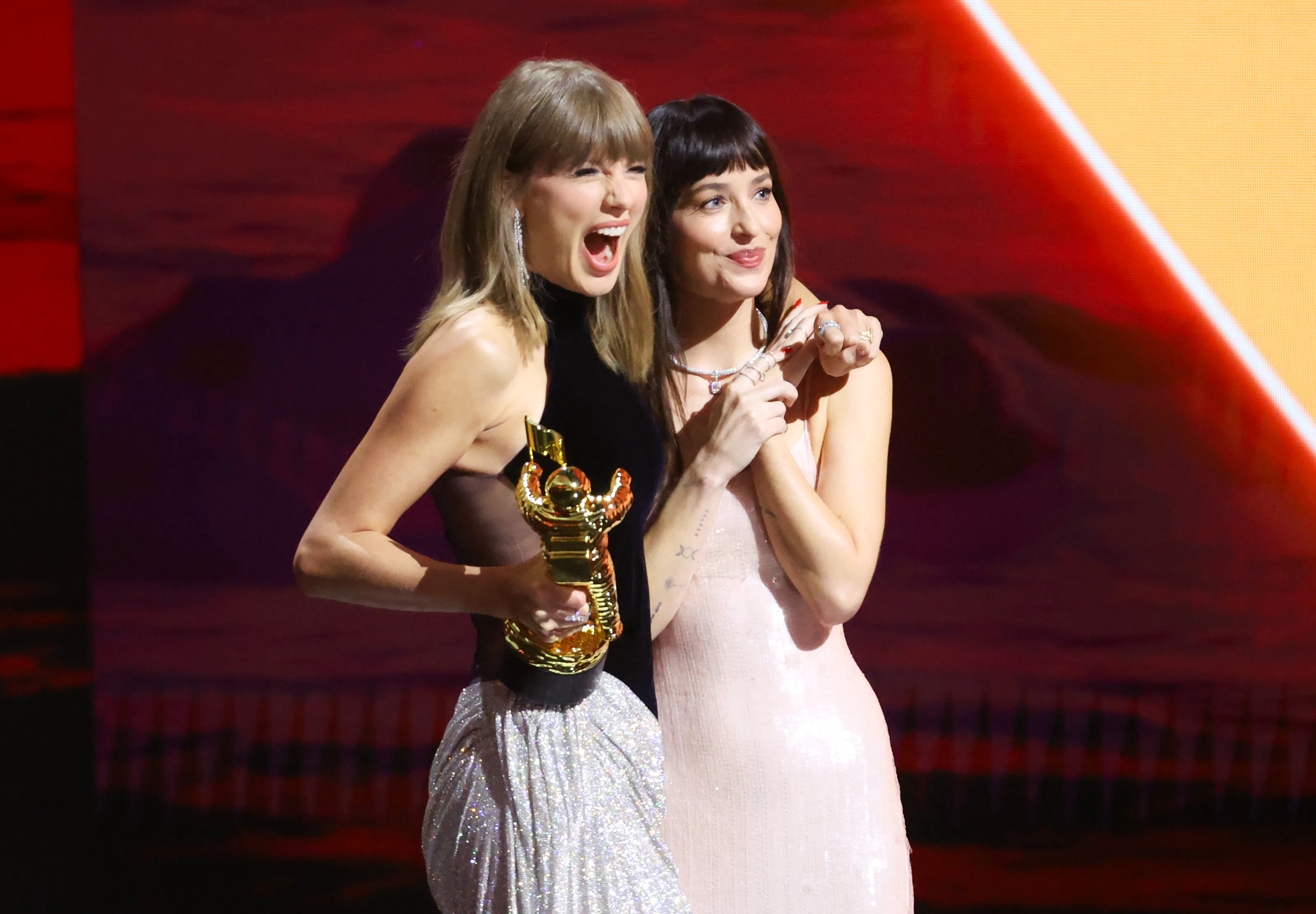 Taylor Swift and Dakota Johnson onstage as Swift accepts the Artist Director Honors at 2026 MTV Vide...