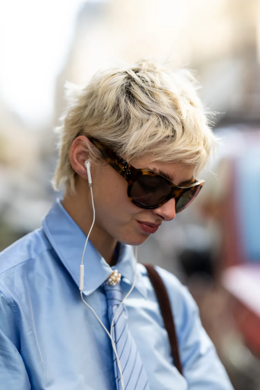 a guest with a blonde pixie cut at paris fashion week s/s '27