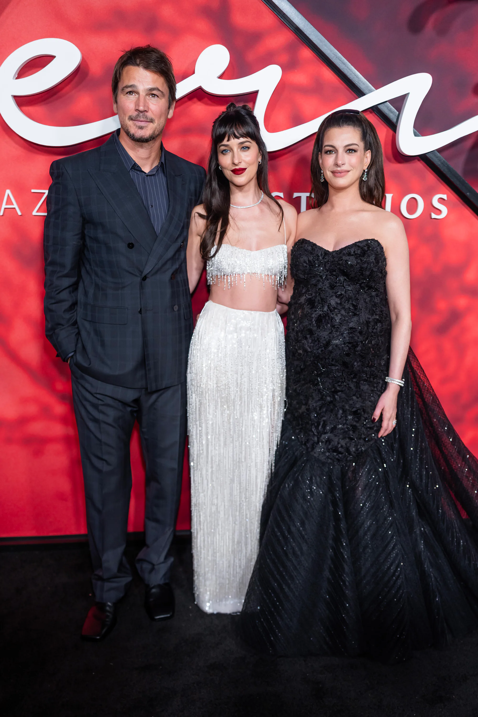 NEW YORK, NEW YORK - SEPTEMBER 29: (L-R) John Hartnett, Dakota Johnson and Anne Hathaway attend Amaz...