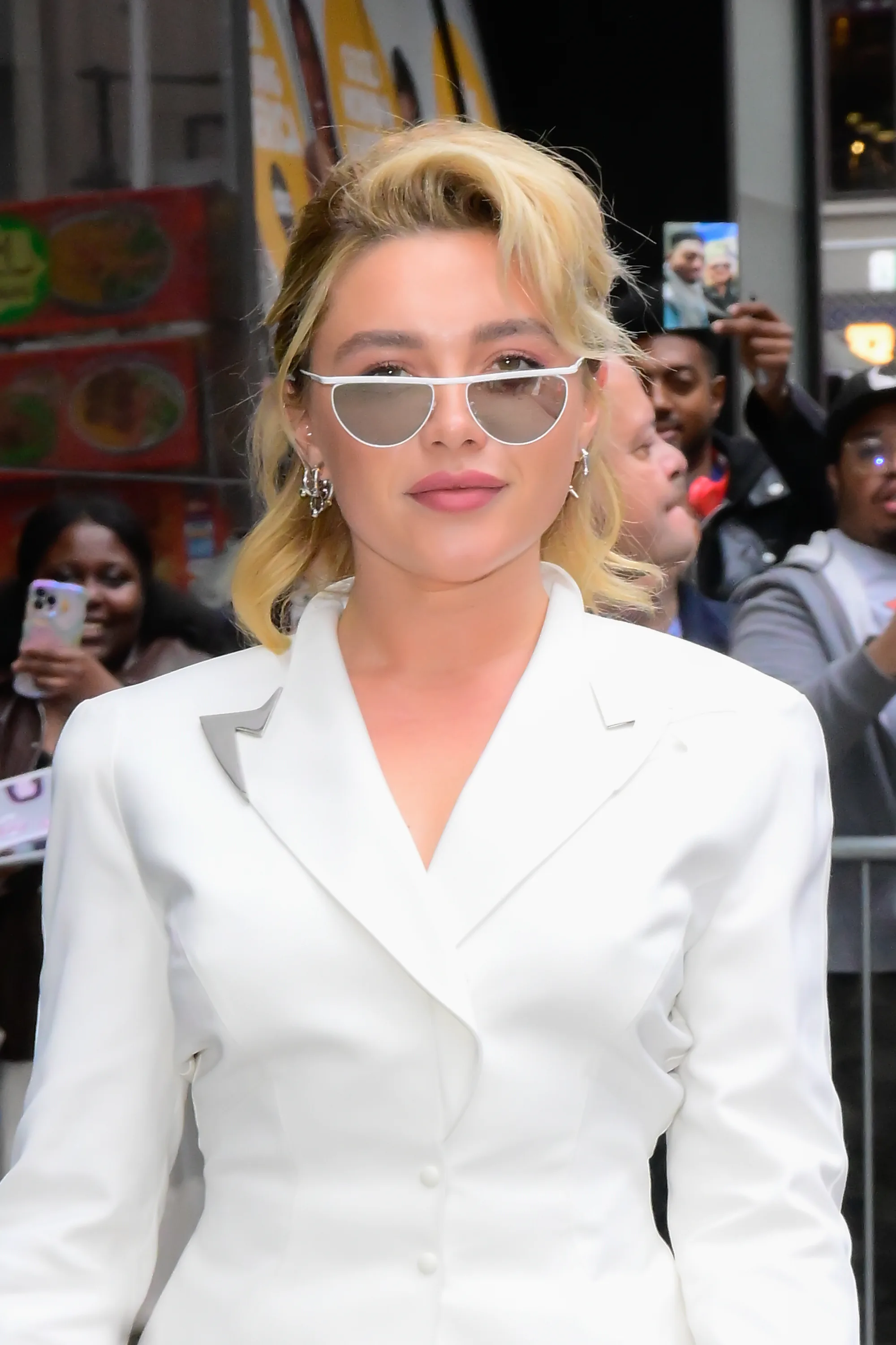 Florence Pugh in 2025 in a white suit with pinky-peach lipstick