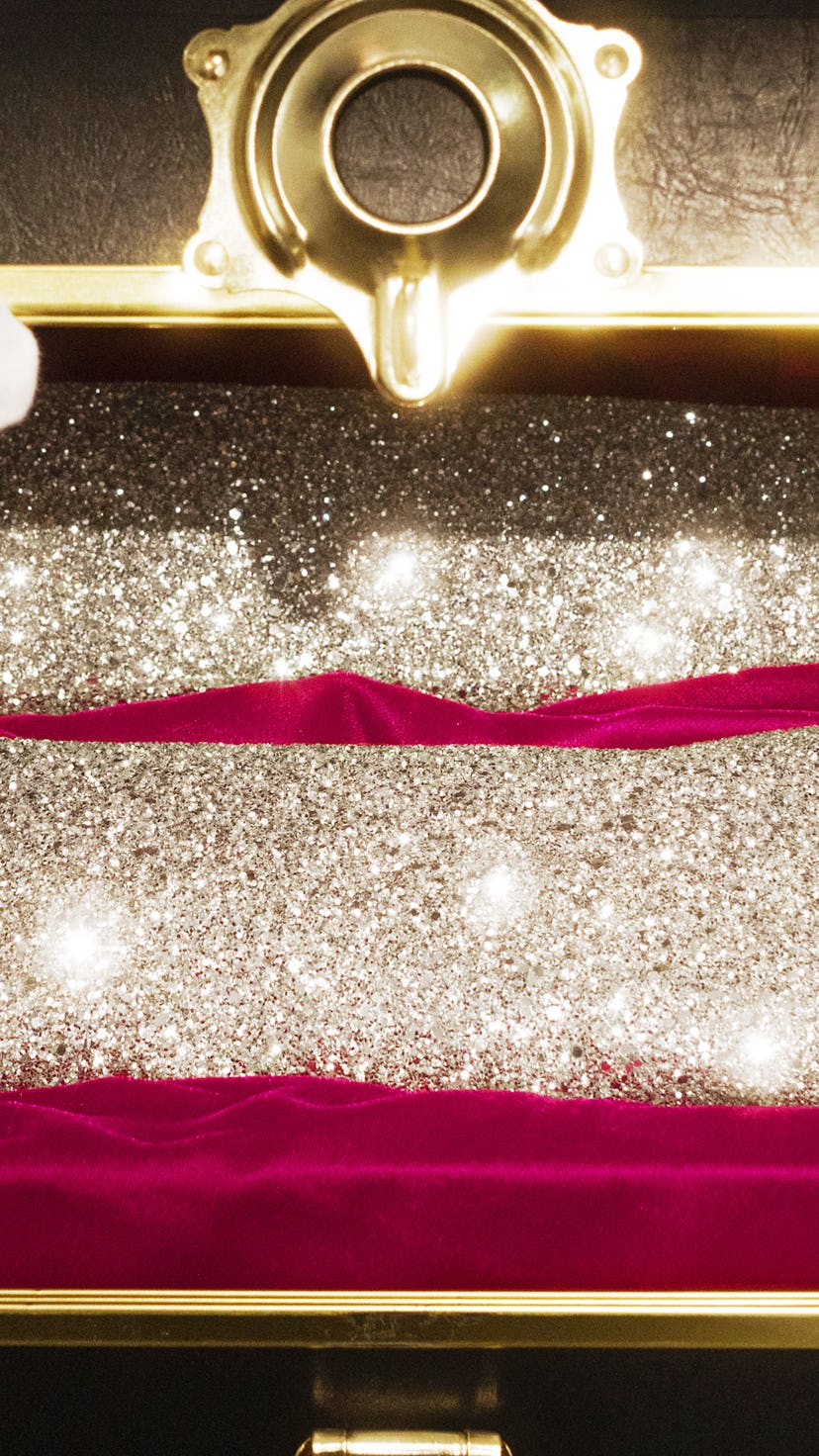 Silver and shiny female Chanel boots with heels in an opened box