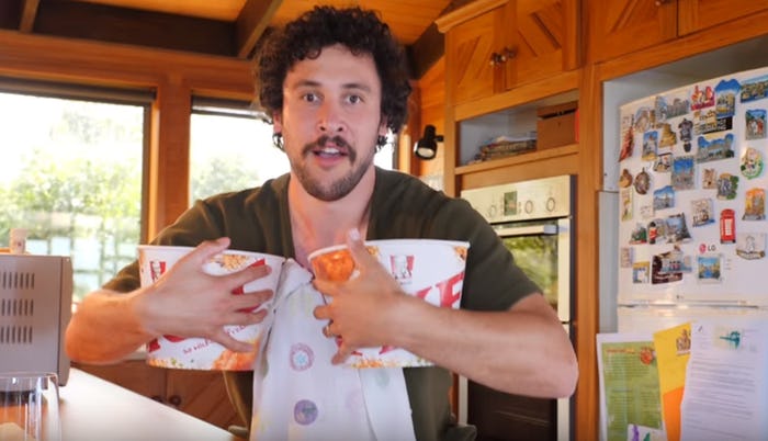 How To Dad vlogger Jordan Watson holding buckets of KFC in his video about supporting women during p...