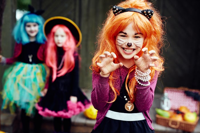 Three girl from Dallas getting ready to trick or treat on halloween