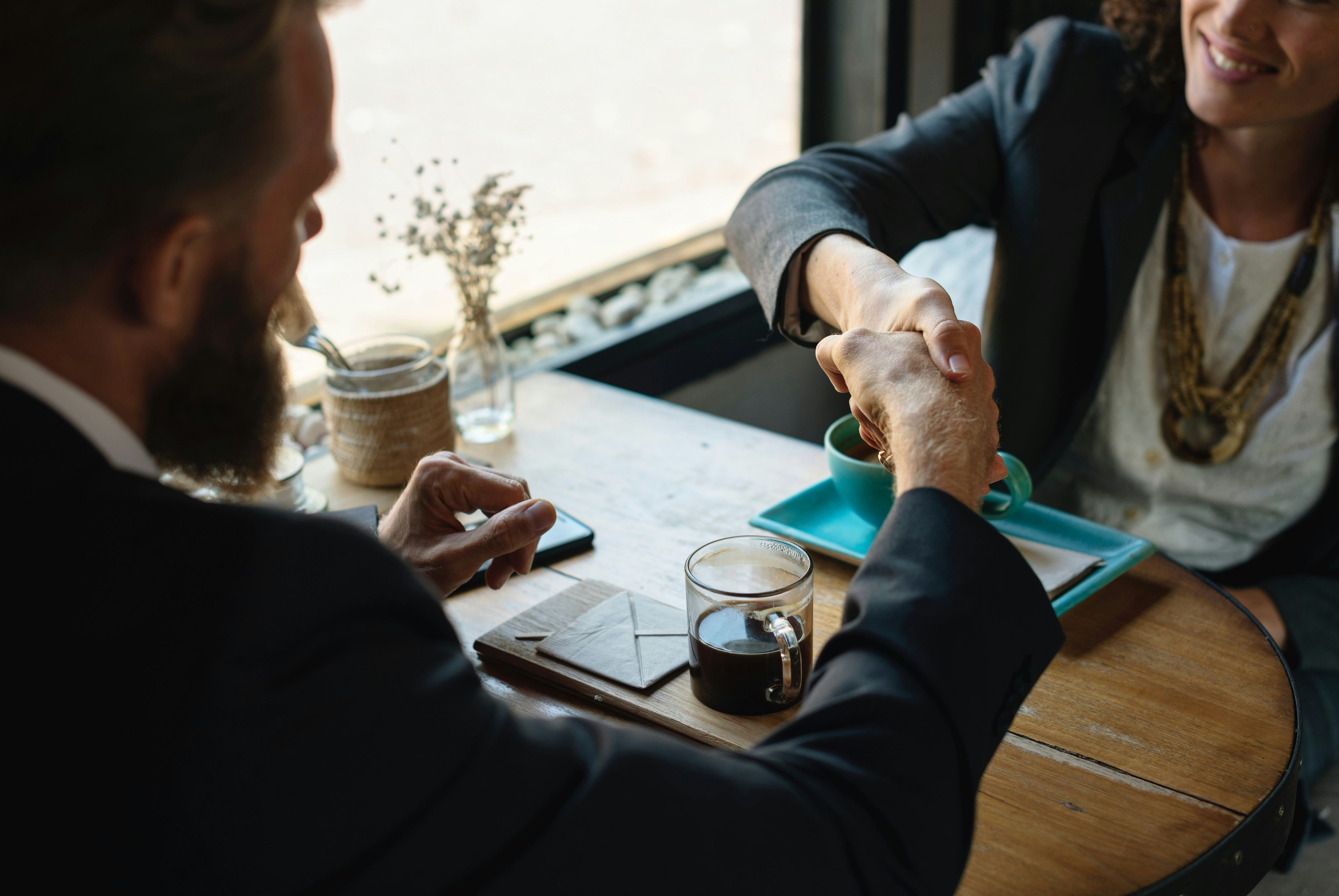 A woman shaking hands with her accountant