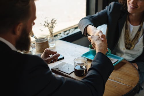 A woman shaking hands with her accountant