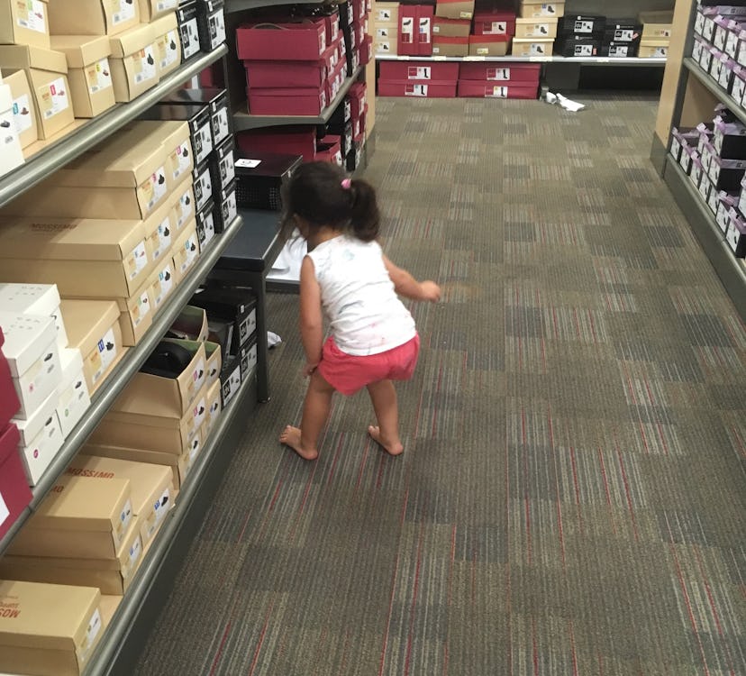 A little girl in a shoe store