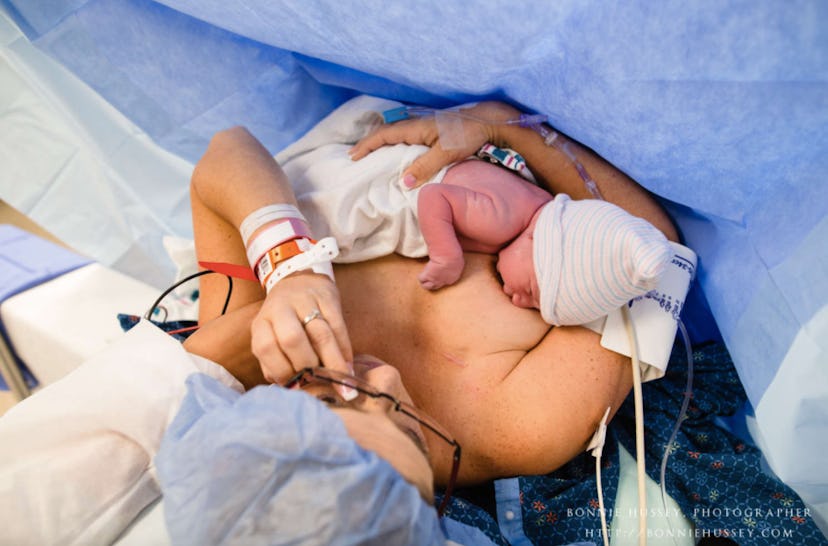 A mom breastfeeding her just born baby while still in the hospital bed