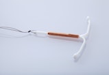 A copper IUD on a white background. Here are 8 signs that your IUD has moved