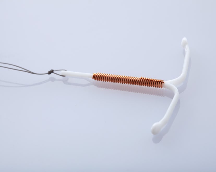 A copper IUD on a white background. Here are 8 signs that your IUD has moved
