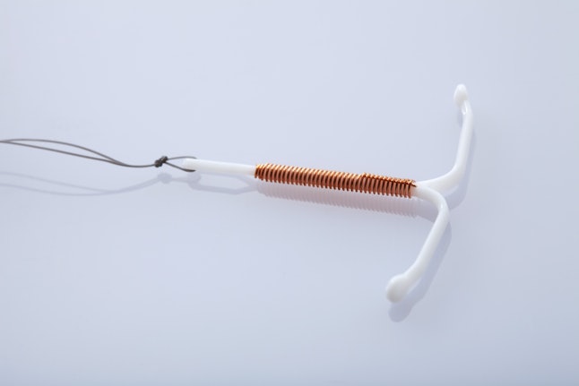 A copper IUD on a white background. Here are 8 signs that your IUD has moved