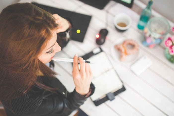 A female entrepreneur writing notes in a notebook