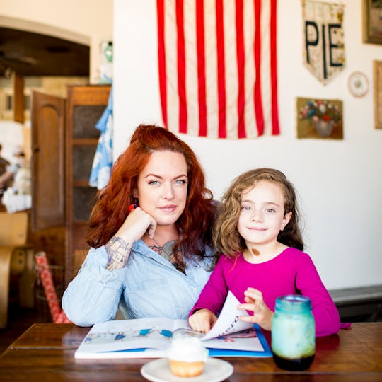 Lane Luerta sitting with her daughter with a book in front of them