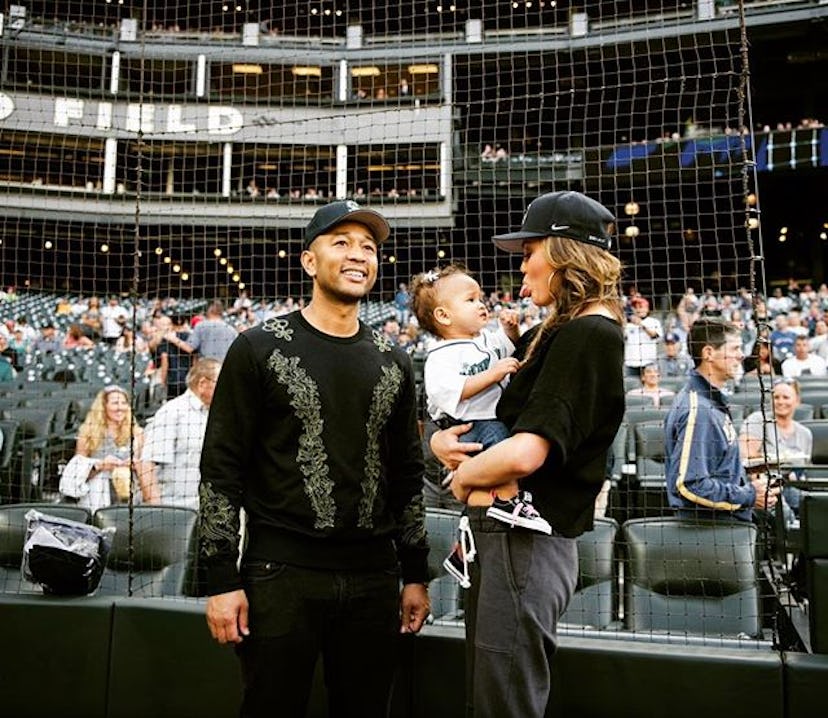 Chrissy and John on a baseball game with their daughter Luna