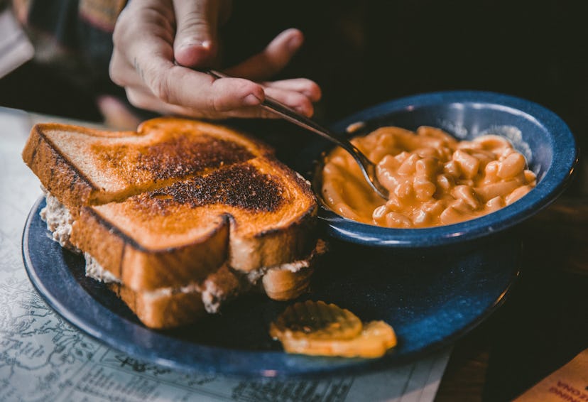 A picture of the breakfast showing the hand reaching out for a bite of it