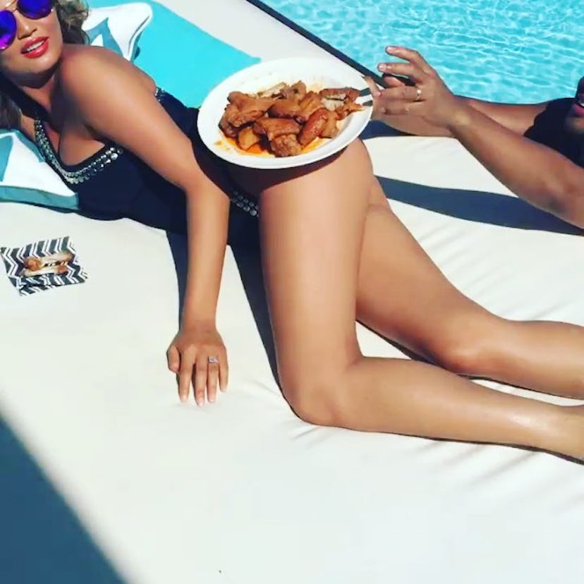 Chrissy lying on the sun lounger with food plate on her leg