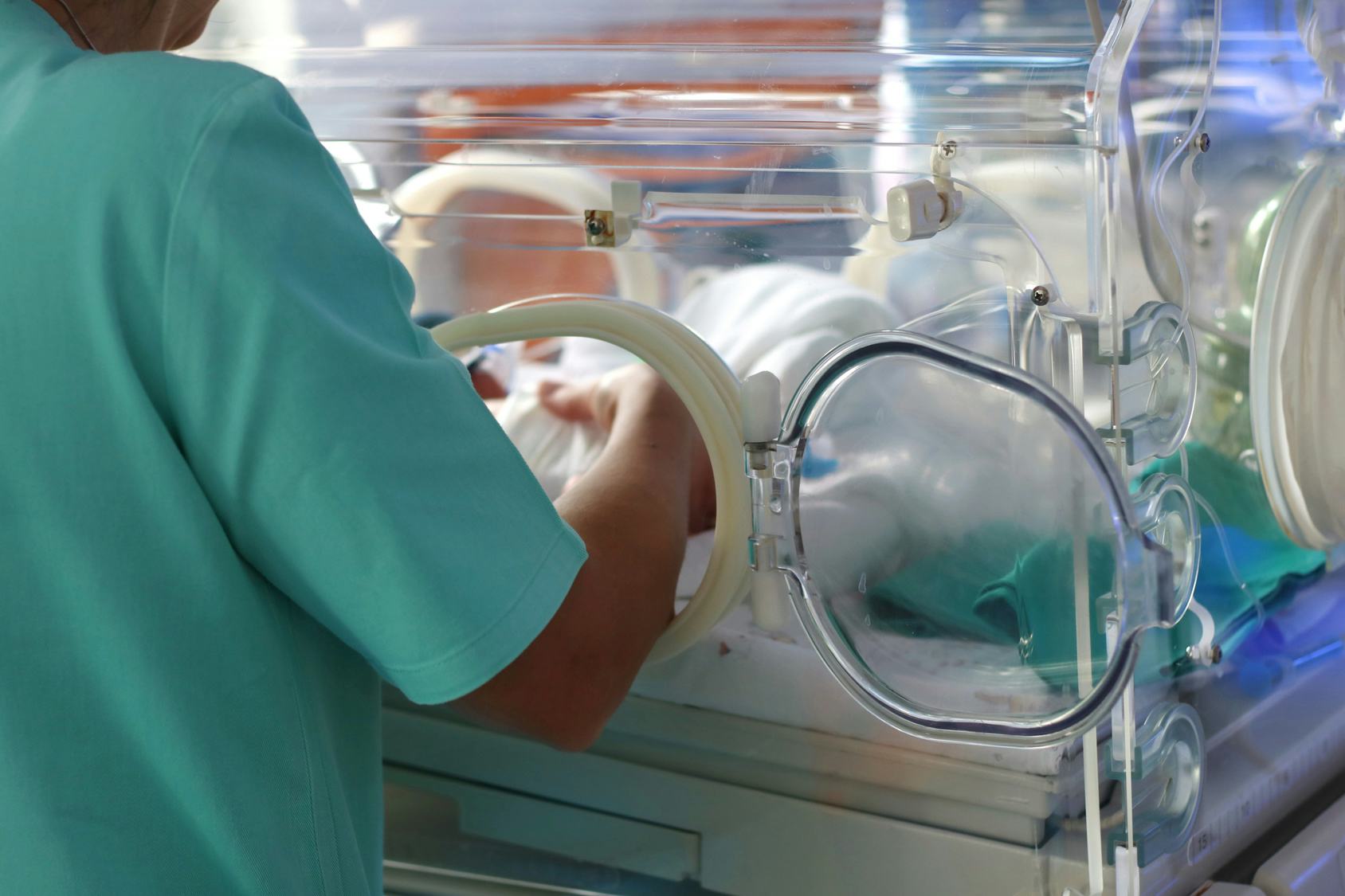 A nurse checking a prematurely born baby in an incubator in The United States