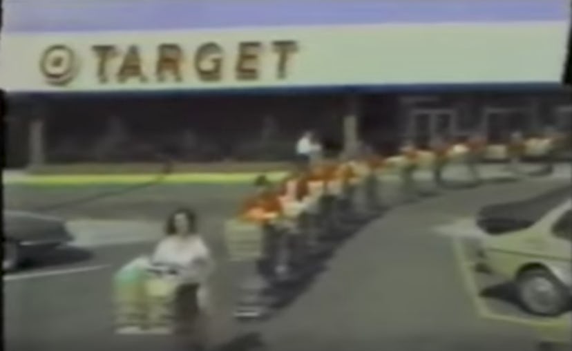 A line of Target shoppers pushing their shopping carts in front of the Target store.