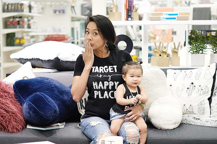 A woman holding a child on her lap, sitting on a couch in a Target store.