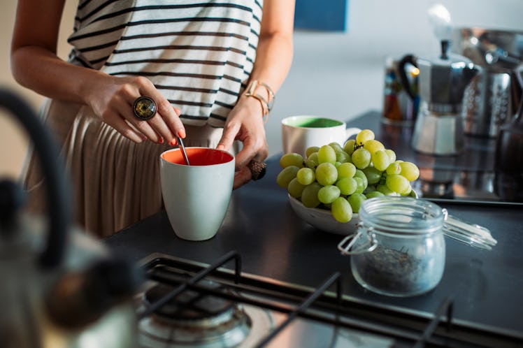 A young woman mixing eucalyptus oils in a cup
