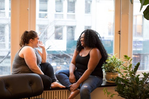 A mother talking to her best friend at a co-working space